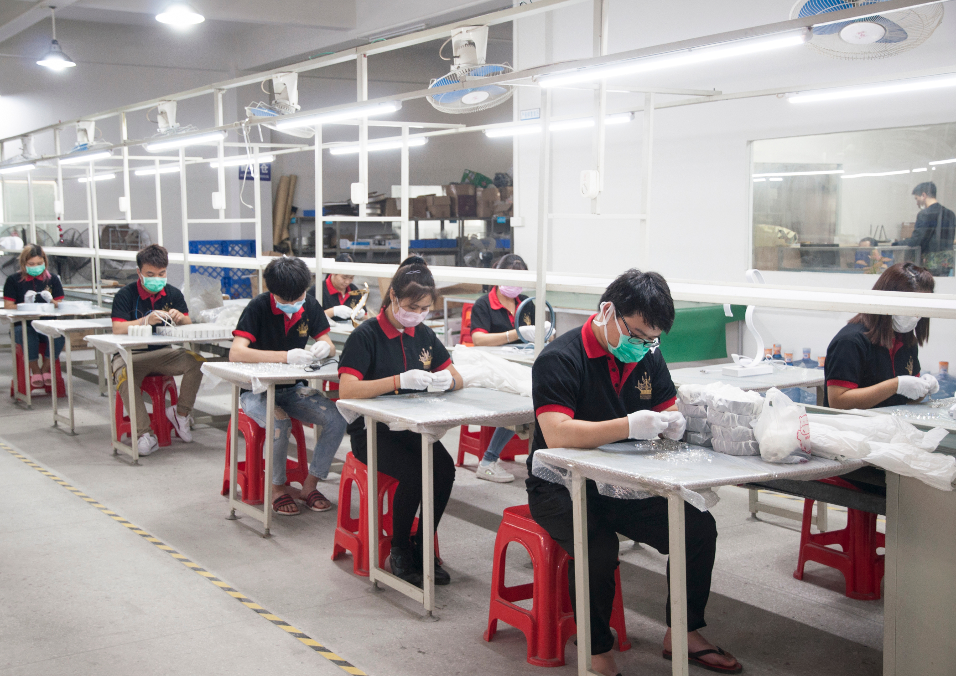 Artisans assembling crystal components by hand in our atelier